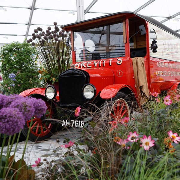 Vintage Brevitt's van surrounded by flowers and plants